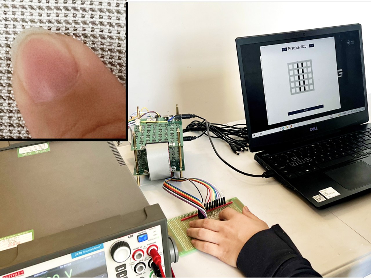 The study setup: a participant rests their hand on the electrode board, connected by a ribbon cable to the drive stack and a laptop showing a practice trial; an inset shows a fingertip touching the woven textile.